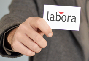 Hand zeigt Visitenkarte mit "labora" Logo